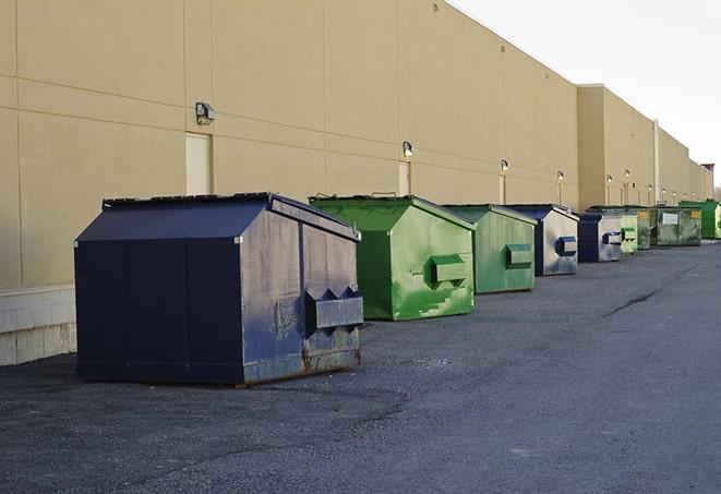 a collection of bright and vibrant dumpsters in a construction zone in Boulder, MT